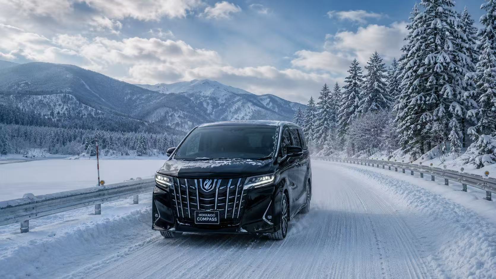 Black Toyota Alphard driving on a snow-covered mountain road in Hokkaido winter