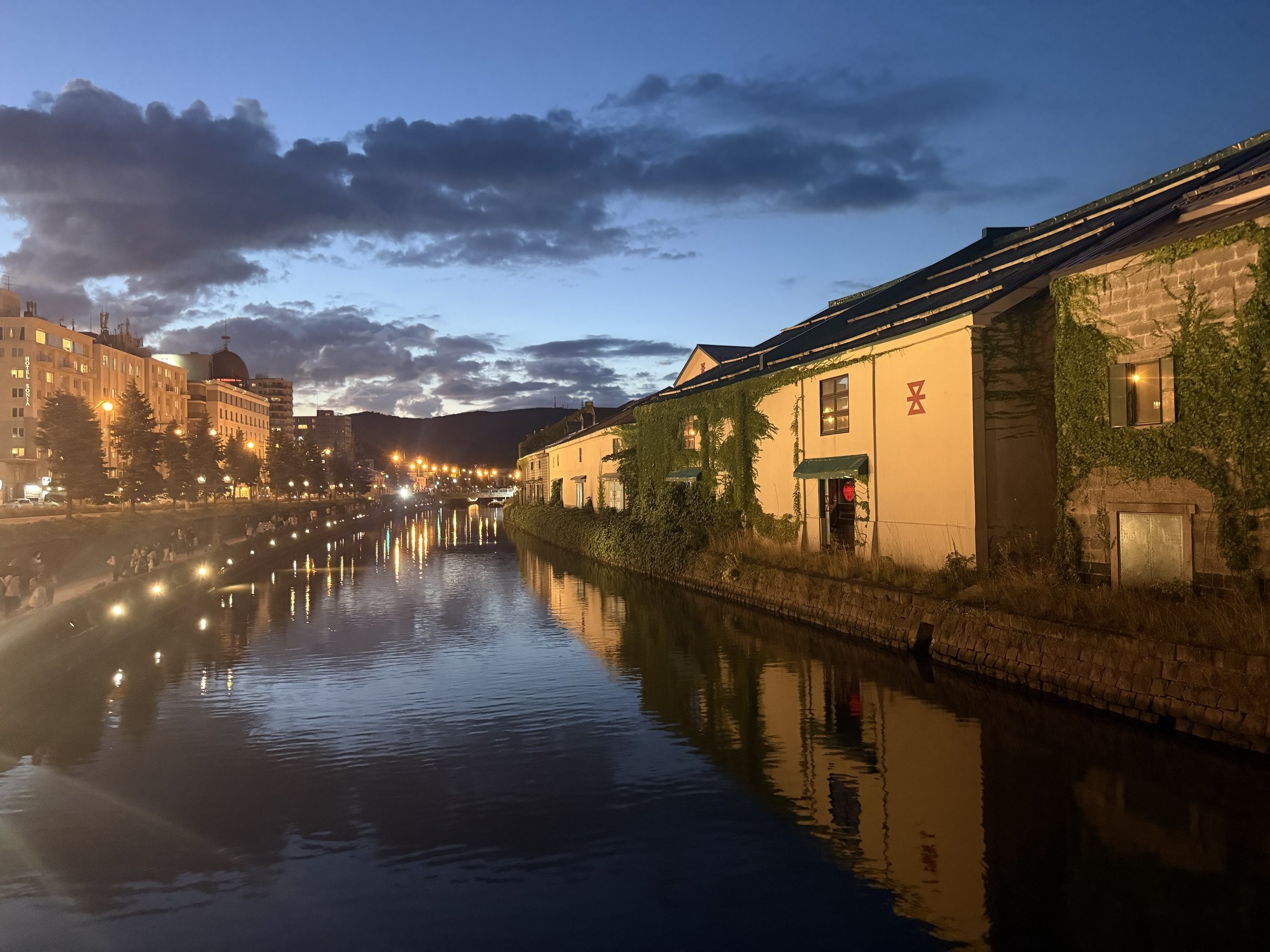 Otaru Canal reflecting warehouse lights beneath a dusky sky
