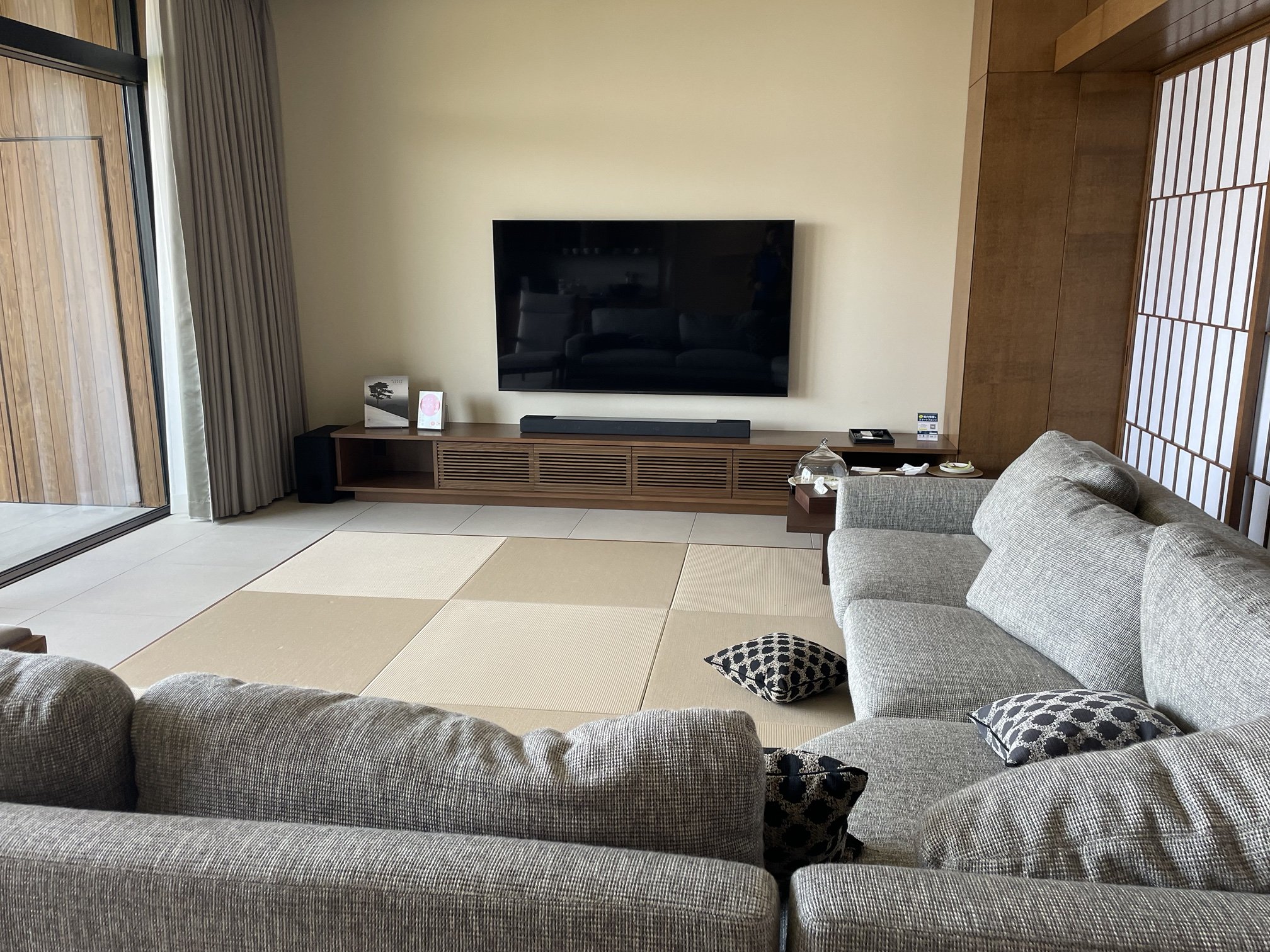 Tatami suite with shoji screens and a low Western bed in a luxury ryokan