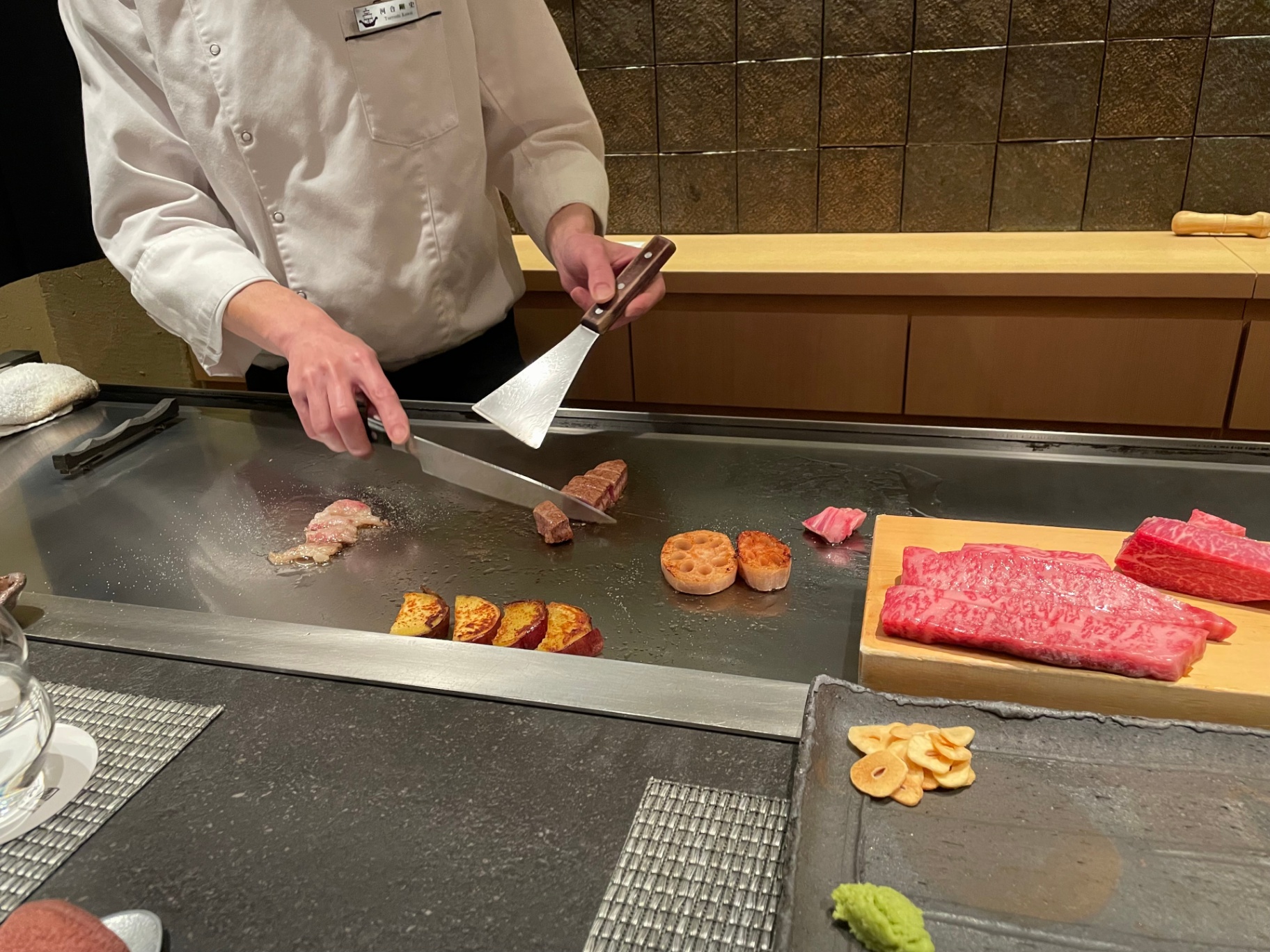 Teppanyaki chef searing Hokkaido wagyu and seasonal vegetables at the counter
