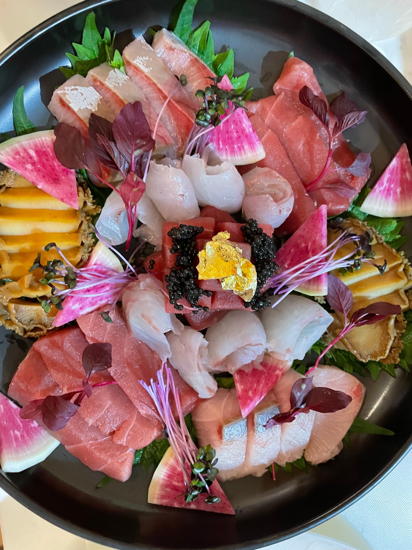 Editorial sashimi platter with ōtoro, hotate and caviar, finished with gold leaf