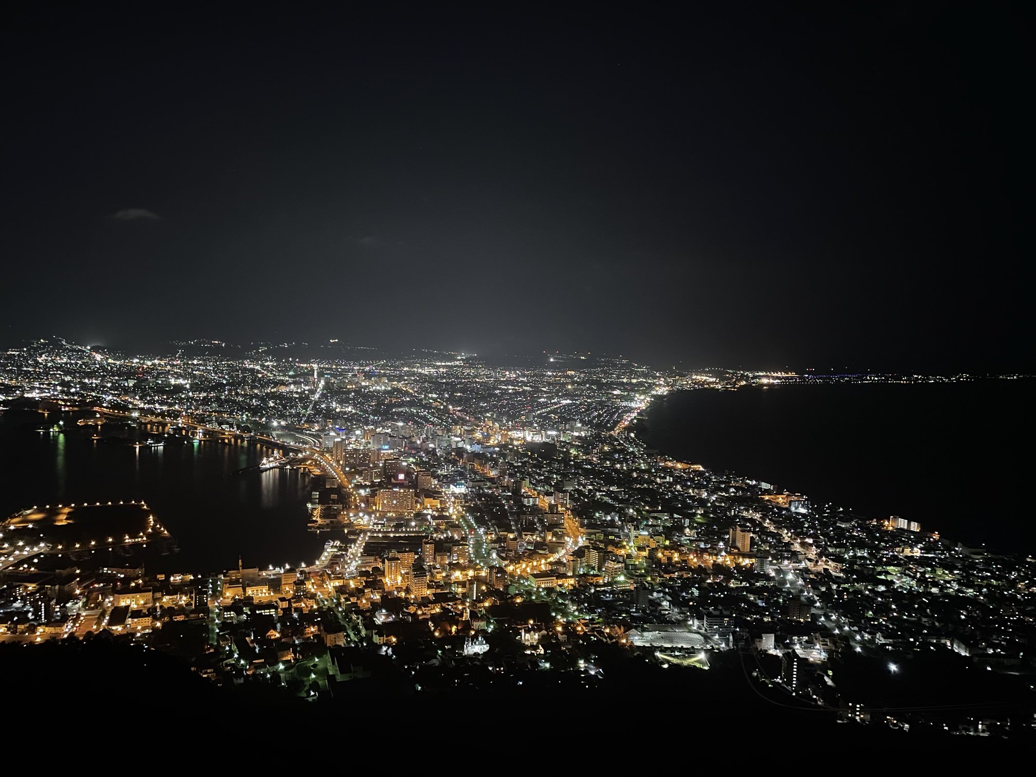 Hakodate city lights between two bays at night, viewed from Mount Hakodate