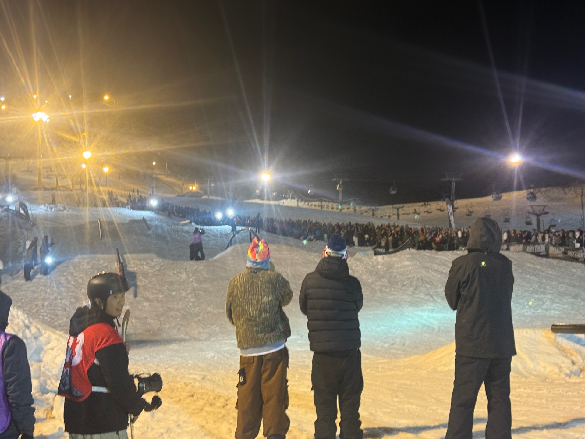 Night ski event in Hokkaido with spectators watching the slope
