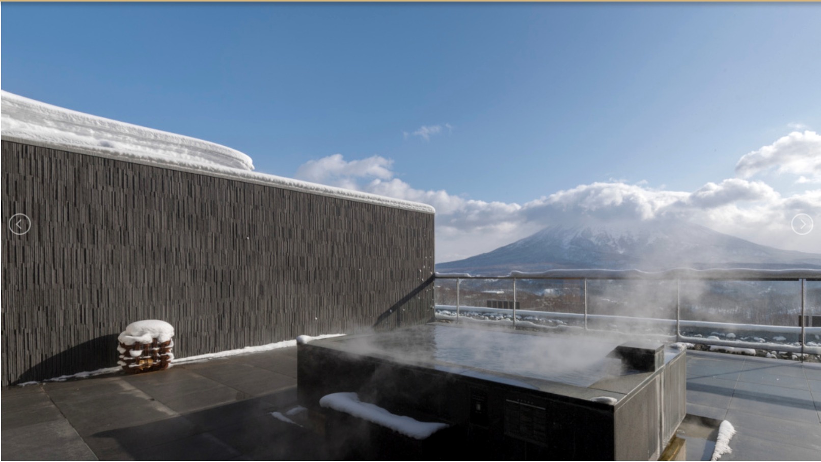 Open-air onsen terrace with a snowy Mt. Yōtei view in winter
