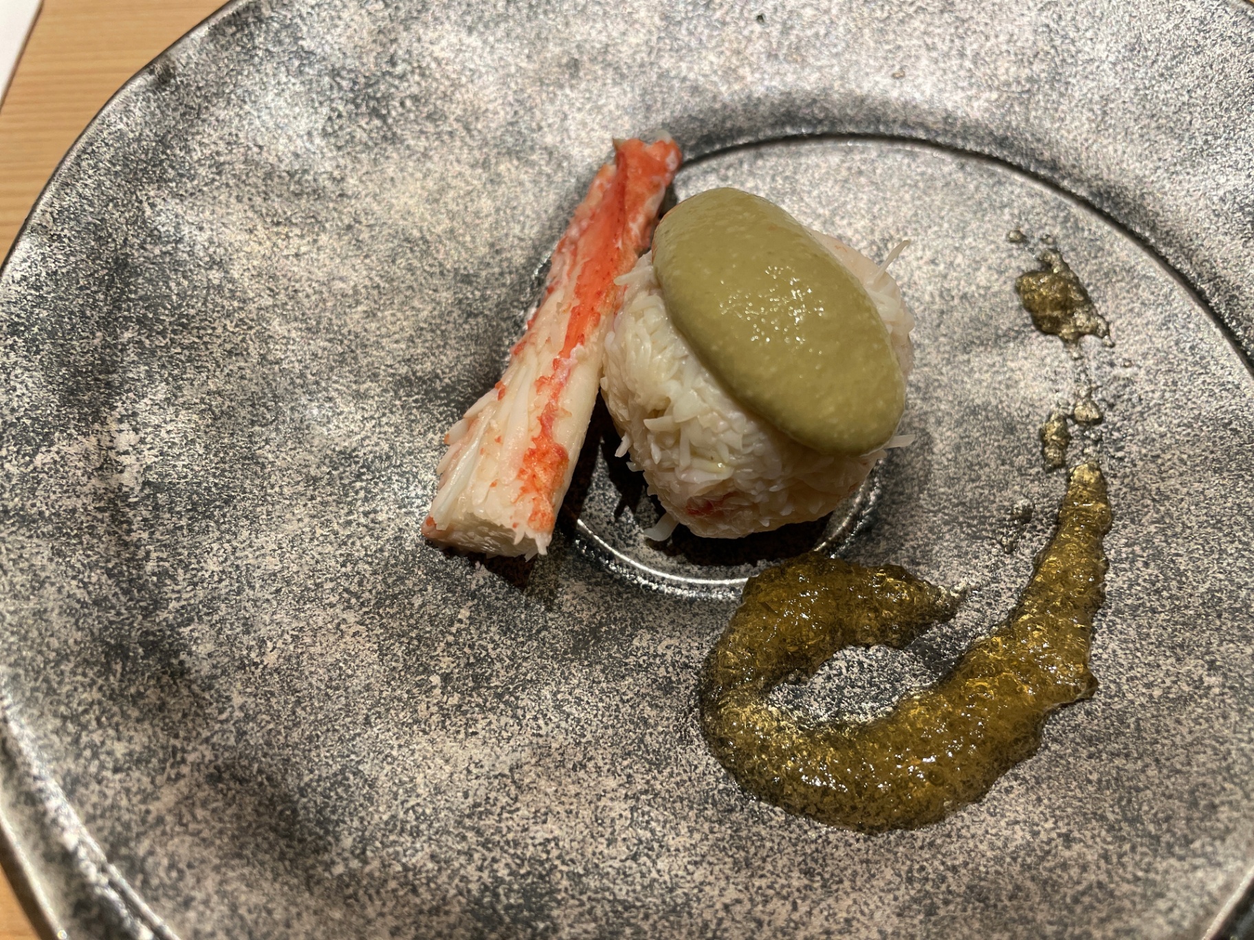 Hokkaido snow-crab amuse with uni mousse and seaweed paste, served on stoneware