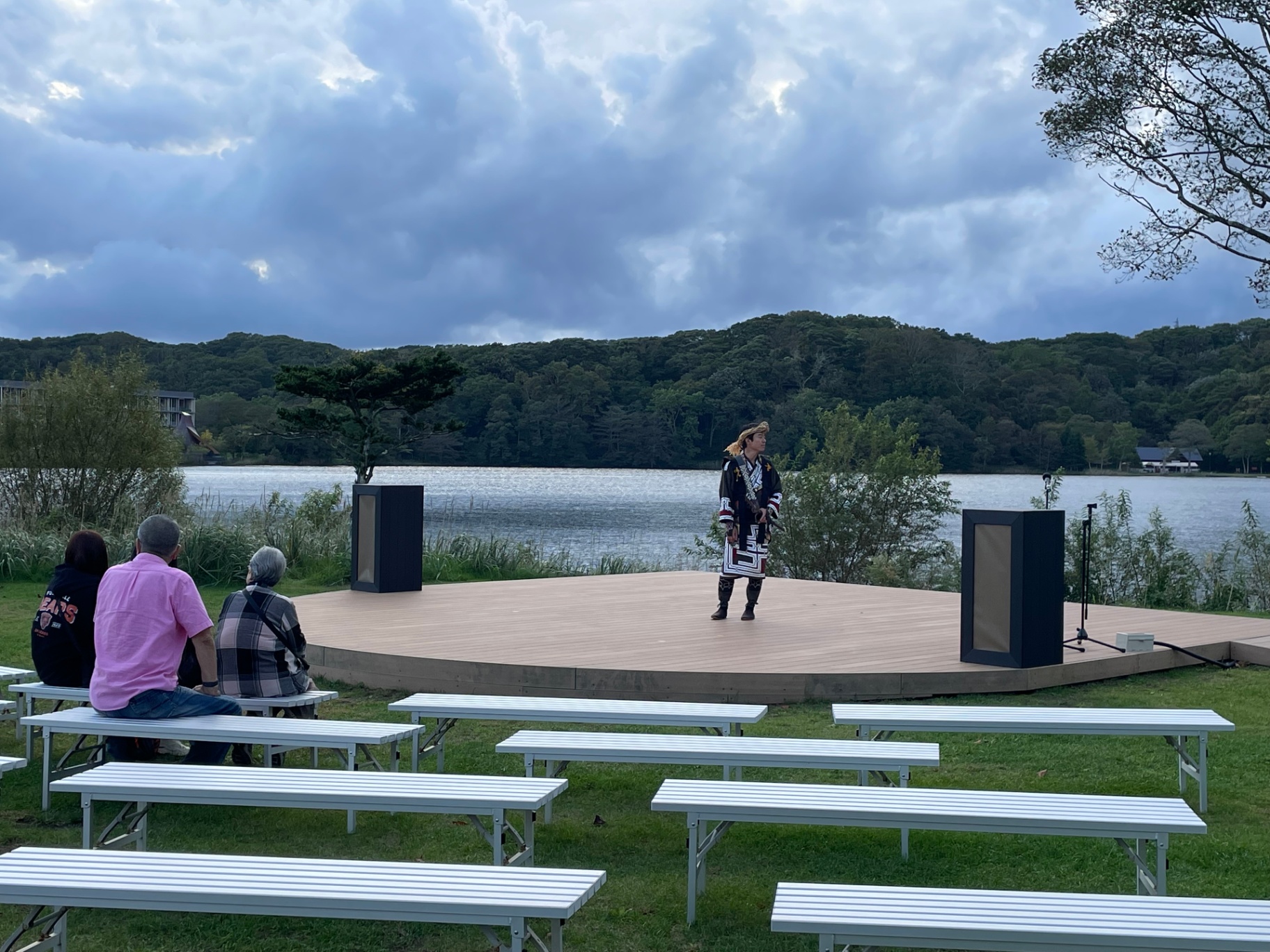 Ainu cultural performance on a lakeside stage at Lake Akan