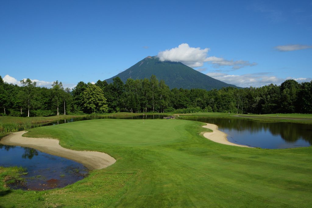 Golf course green with Mt. Yotei in the background in Niseko
